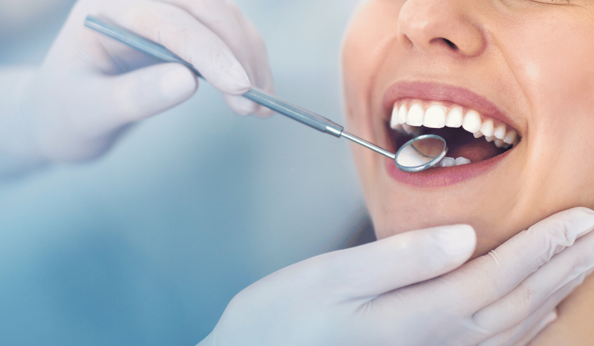 new dental patient getting teeth examined in Oceanside, CA