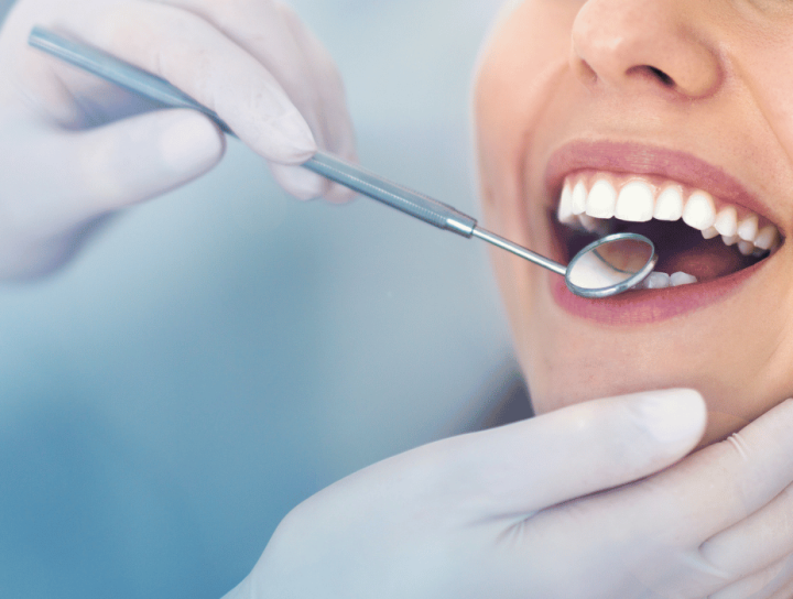 new dental patient getting teeth examined in Oceanside, CA
