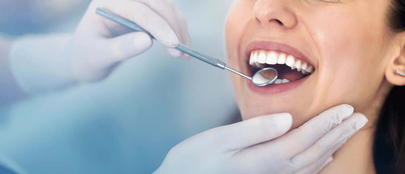 new dental patient getting teeth examined in Oceanside, CA